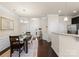 Bright dining room with hardwood floors and access to the kitchen and entryway at 2430 Kensington Station Pkwy, Charlotte, NC 28210