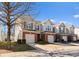 Three townhouses with brick fronts, garages, and small yards at 2430 Kensington Station Pkwy, Charlotte, NC 28210