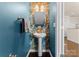 Stylish powder room with a pedestal sink and decorative wallpaper at 2430 Kensington Station Pkwy, Charlotte, NC 28210