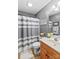 Clean bathroom with a striped shower curtain and wooden vanity at 2740 Hill Top Dr, Salisbury, NC 28147