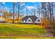 House with a green lawn, trees, and a basketball hoop at 2740 Hill Top Dr, Salisbury, NC 28147