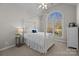 Charming bedroom with a white four-poster bed and a view of the backyard at 3065 River Bend Dr, Tega Cay, SC 29708