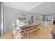 Spacious dining area with hardwood floors, a large wooden table, and a bench at 3065 River Bend Dr, Tega Cay, SC 29708