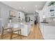 Modern kitchen with white cabinets, granite countertops, and stainless steel appliances at 3065 River Bend Dr, Tega Cay, SC 29708