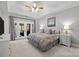 Spacious main bedroom with a king-size bed and access to a private patio at 3065 River Bend Dr, Tega Cay, SC 29708