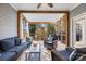 Relaxing screened porch with wicker furniture and a view of the woods at 3065 River Bend Dr, Tega Cay, SC 29708