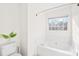 Clean white bathroom with a soaking tub and a window offering natural light at 3304 Caernarvon Ct, Fort Mill, SC 29715