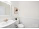 Clean bathroom with white sink, toilet, and wainscoting at 3304 Caernarvon Ct, Fort Mill, SC 29715