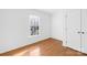 This empty bedroom has light-colored hardwood floors, a window, and a closet at 3304 Caernarvon Ct, Fort Mill, SC 29715