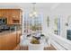 Bright breakfast nook features a glass table, white chairs, and natural light from a large window at 3304 Caernarvon Ct, Fort Mill, SC 29715