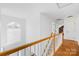 Hallway with beautiful staircase and natural light from large arched window at 3304 Caernarvon Ct, Fort Mill, SC 29715