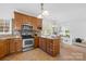 Kitchen with wooden cabinets, stainless steel appliances, and breakfast bar at 3304 Caernarvon Ct, Fort Mill, SC 29715