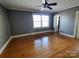 Spacious bedroom with hardwood floors, ceiling fan and gray walls at 352 7Th Nw St, Hickory, NC 28601