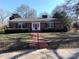 Brick house with a red door and nicely landscaped lawn at 352 7Th Nw St, Hickory, NC 28601