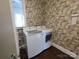 Laundry room with washer, dryer, and patterned wallpaper at 352 7Th Nw St, Hickory, NC 28601