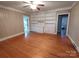 Living room with built-in shelving, hardwood floors, and ceiling fan at 352 7Th Nw St, Hickory, NC 28601