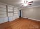 Living room with built-in shelving, hardwood floors, and ceiling fan at 352 7Th Nw St, Hickory, NC 28601