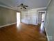 Living room with built-in shelving, hardwood floors, and ceiling fan at 352 7Th Nw St, Hickory, NC 28601