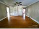 Living room with built-in shelving, hardwood floors, and ceiling fan at 352 7Th Nw St, Hickory, NC 28601