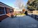 Small patio with table and chairs, next to brick wall at 352 7Th Nw St, Hickory, NC 28601