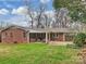 Brick ranch house with covered patio and attached wooden gate at 3624 Trent St, Charlotte, NC 28209