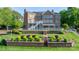 Beautiful backyard with a brick retaining wall, lush landscaping, and brick home at 4165 54Th Ne Ave, Hickory, NC 28601