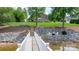A lush backyard with stairs leading to a dock on the water, seating, and a firepit area at 4165 54Th Ne Ave, Hickory, NC 28601