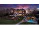 An expansive backyard with a pool, landscaped gardens, and a patio at twilight at 4165 54Th Ne Ave, Hickory, NC 28601