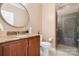 Stylish bathroom featuring a granite countertop, round mirror, and glass-enclosed shower for a spa-like experience at 4165 54Th Ne Ave, Hickory, NC 28601