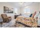 Cozy bedroom featuring a comfortable armchair, two windows, and a plush patterned bedspread at 4165 54Th Ne Ave, Hickory, NC 28601