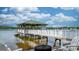 Dock on the lake with a covered structure and Adirondack chairs for relaxing by the water at 4165 54Th Ne Ave, Hickory, NC 28601