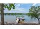 A dock on the lake includes a covered area with seating, a walkway, and steps into the water at 4165 54Th Ne Ave, Hickory, NC 28601