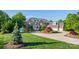 Stunning brick home with lush landscaping, circular driveway, and attached three-car garage at 4165 54Th Ne Ave, Hickory, NC 28601