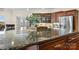 Close-up of a kitchen island featuring a granite countertop with dark wood cabinetry and stainless appliances at 4165 54Th Ne Ave, Hickory, NC 28601