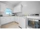 Bright laundry room with white cabinets, countertops, sink, washer, and dryer at 4165 54Th Ne Ave, Hickory, NC 28601