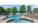 Backyard pool and spa with stone accents and a wrought iron safety fence overlooking the lake at 4165 54Th Ne Ave, Hickory, NC 28601