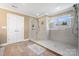 Modern shower with glass enclosure, neutral tiles, and window allowing natural light at 4165 54Th Ne Ave, Hickory, NC 28601