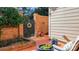 Small brick patio with a wooden gate and potted plants at 4413 Simsbury Rd, Charlotte, NC 28226