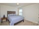 Serene bedroom with a queen-size bed and window at 4418 Huntley Glen Dr, Pineville, NC 28134