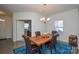 Elegant dining room with a live-edge table and chandelier at 4418 Huntley Glen Dr, Pineville, NC 28134