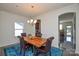 Bright dining room with wood table and access to kitchen at 4418 Huntley Glen Dr, Pineville, NC 28134