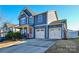 Two-story house featuring gray siding, a two-car garage, and a well-manicured lawn at 4418 Huntley Glen Dr, Pineville, NC 28134