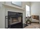 Living room fireplace with black surround and wood mantel at 4418 Huntley Glen Dr, Pineville, NC 28134