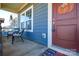 Front porch with red door and wicker chairs at 4418 Huntley Glen Dr, Pineville, NC 28134