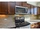 Kitchen boasts granite counters and stainless steel appliances at 4418 Huntley Glen Dr, Pineville, NC 28134