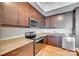 Modern kitchen with granite countertop and dark cabinets at 4620 Piedmont Row Dr # 509, Charlotte, NC 28210