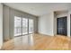 Living room with hardwood floors and sliding doors to balcony at 4620 Piedmont Row Dr # 509, Charlotte, NC 28210