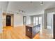 Open concept living area with hardwood floors and kitchen island at 4620 Piedmont Row Dr # 509, Charlotte, NC 28210