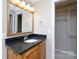 Bathroom with dark vanity, mirror, and linen closet at 4750 Pennington Meadows Cir, Rock Hill, SC 29732