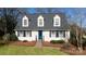 White house with blue door, shutters, and pine straw landscaping at 4750 Pennington Meadows Cir, Rock Hill, SC 29732